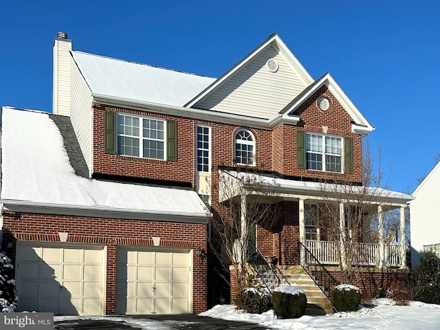 view of front of property with a garage and covered porch