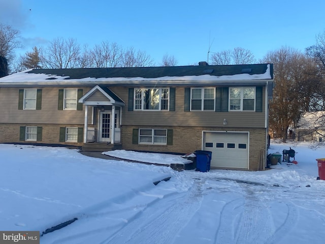 split foyer home featuring a garage and brick siding