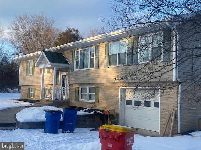 split foyer home with brick siding and an attached garage