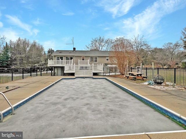 exterior space with fence, a fire pit, and a wooden deck