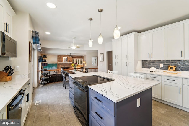 kitchen with white cabinets, a kitchen island, hanging light fixtures, and black appliances