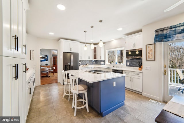 kitchen with white cabinetry, hanging light fixtures, and a center island