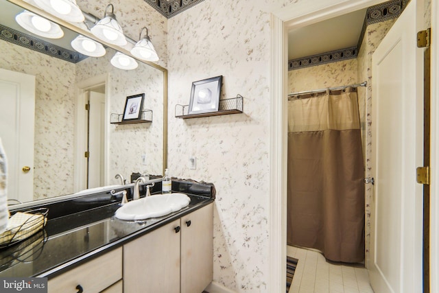 bathroom featuring vanity and curtained shower