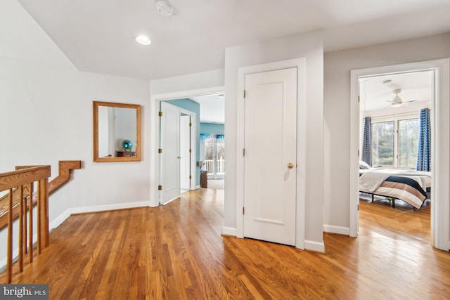 hallway with hardwood / wood-style floors