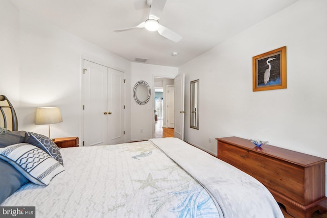 bedroom with ceiling fan and a closet