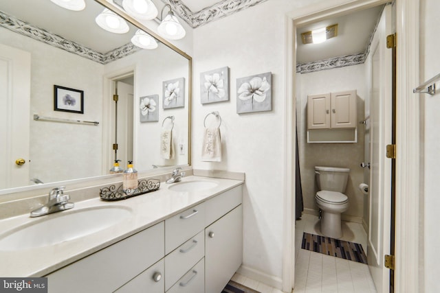 bathroom featuring tile patterned floors, vanity, and toilet