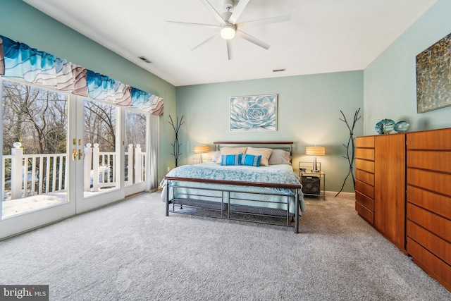 bedroom with access to exterior, ceiling fan, and carpet