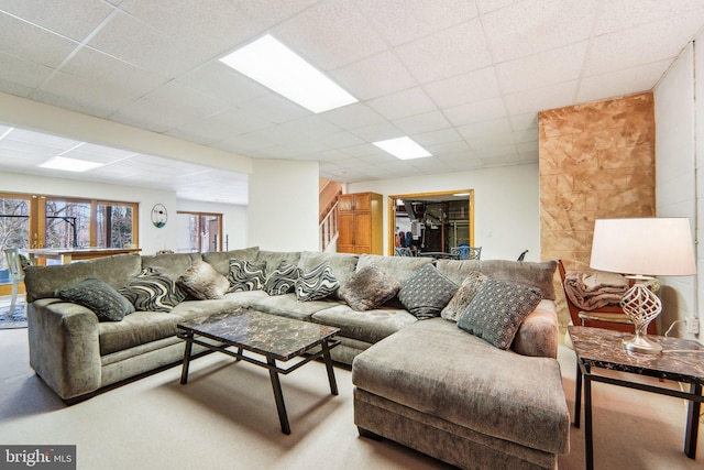 living room with a drop ceiling