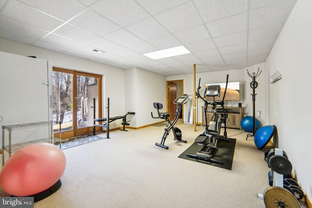 exercise room featuring carpet and a drop ceiling