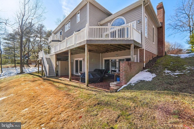 back of house with a yard, a deck, and a patio