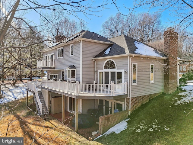 back of property featuring a wooden deck and a balcony