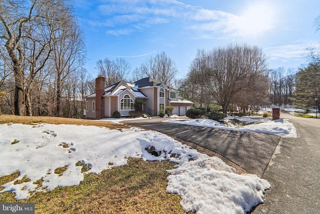 view of snowy exterior featuring a garage