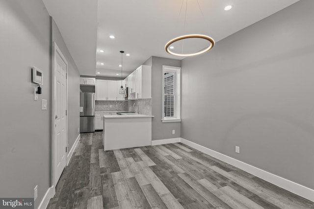 unfurnished living room featuring sink and light hardwood / wood-style flooring