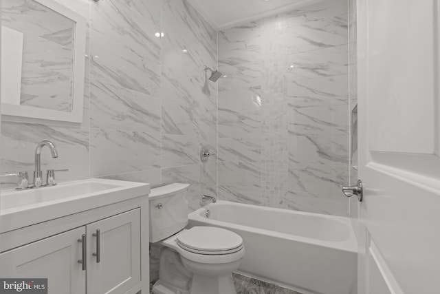 full bathroom featuring tile walls, toilet, vanity, and tiled shower / bath