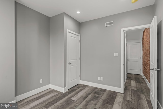 unfurnished room with dark hardwood / wood-style floors