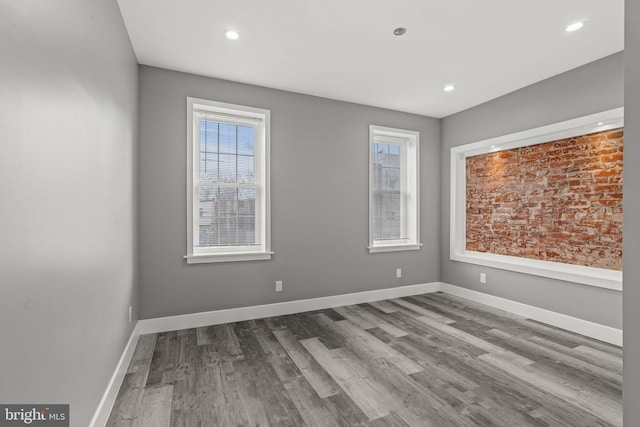 empty room with hardwood / wood-style floors