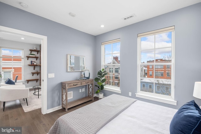 bedroom with dark hardwood / wood-style floors