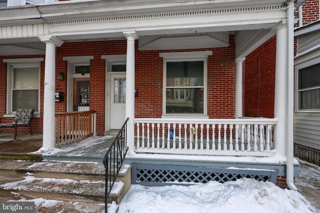 view of snow covered property entrance