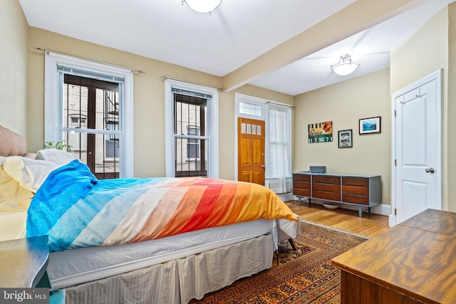 bedroom featuring hardwood / wood-style floors and multiple windows