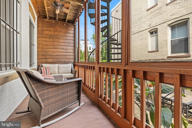 wooden balcony featuring a deck, outdoor lounge area, and ceiling fan