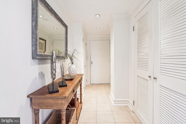 corridor featuring light tile patterned flooring and ornamental molding