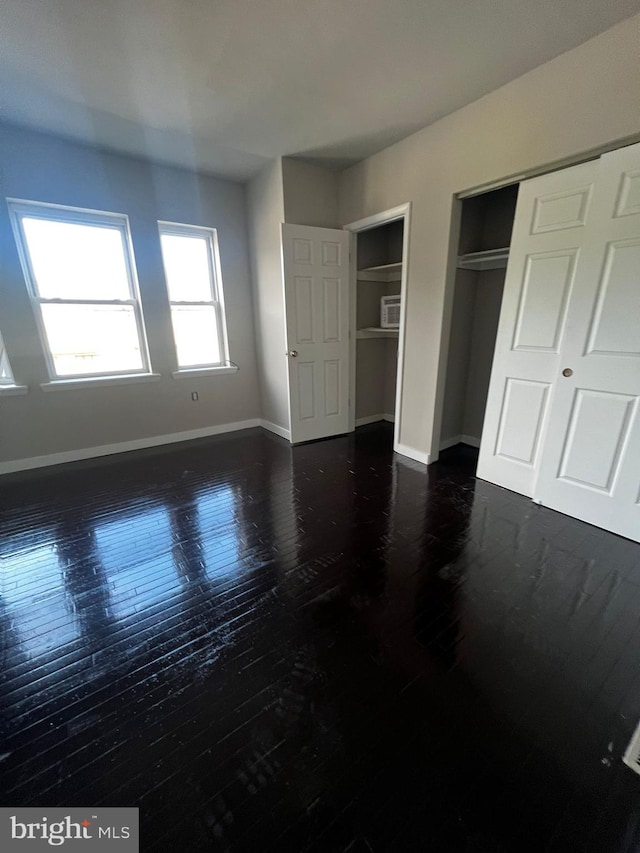 unfurnished bedroom featuring two closets