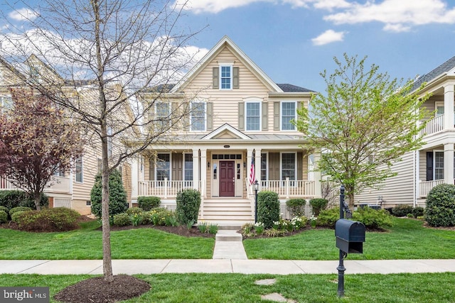 view of front of property with covered porch and a front yard