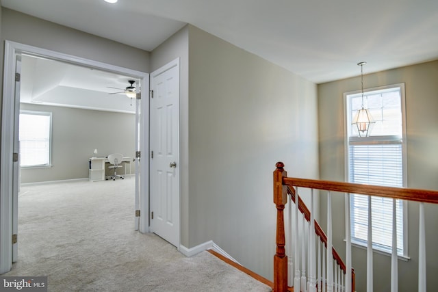 corridor featuring light colored carpet