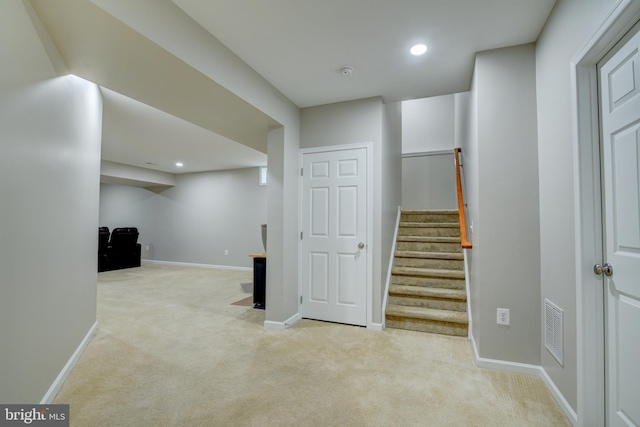 interior space featuring light carpet