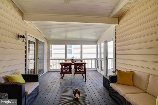 sunroom with vaulted ceiling with beams