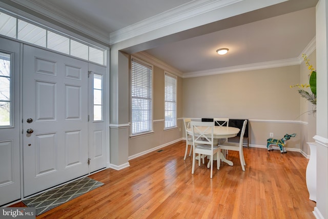 entryway featuring crown molding, light hardwood / wood-style floors, and a healthy amount of sunlight