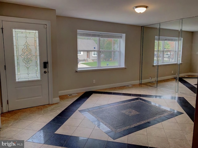 tiled entryway with plenty of natural light