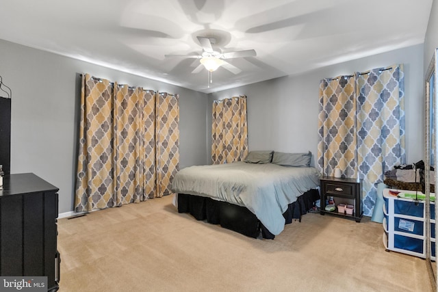 bedroom with ceiling fan and light colored carpet