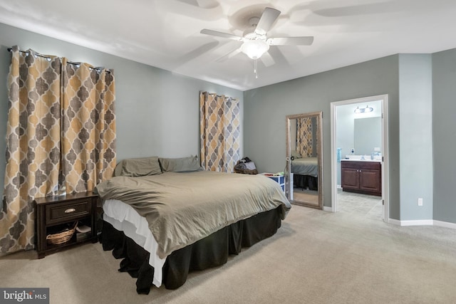 carpeted bedroom featuring ceiling fan and ensuite bathroom