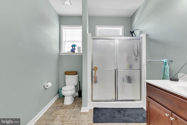 bathroom with toilet, walk in shower, and vanity