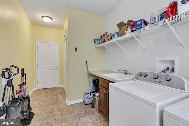 laundry room featuring sink, independent washer and dryer, and cabinets