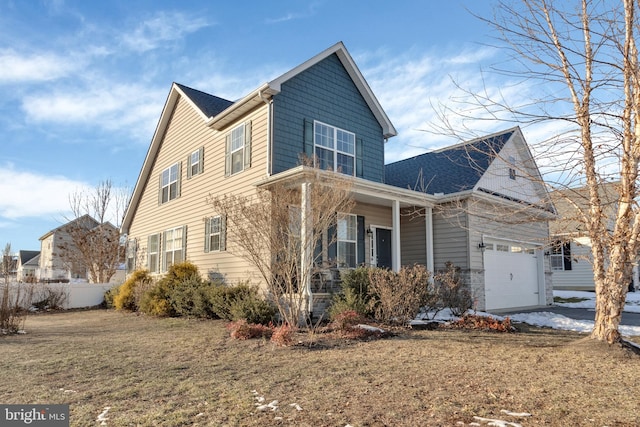 view of front of property with a garage and a front lawn