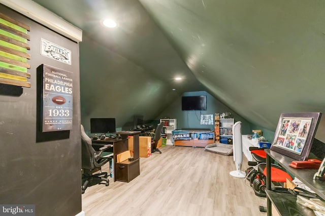 interior space with light hardwood / wood-style floors and lofted ceiling