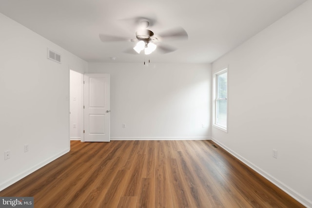 unfurnished room with ceiling fan and dark hardwood / wood-style floors