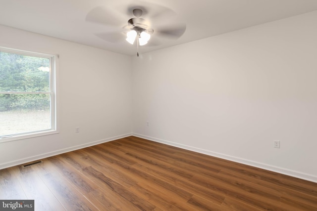 empty room featuring dark wood-type flooring and ceiling fan