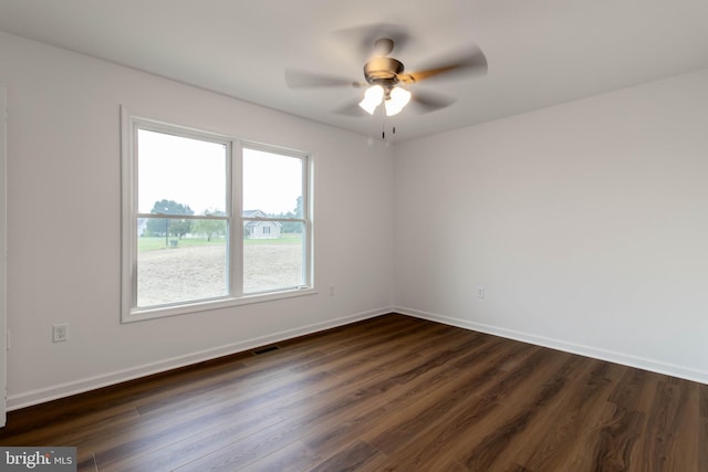 unfurnished room with ceiling fan and dark hardwood / wood-style floors