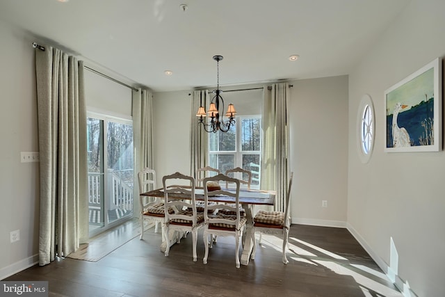 dining space with a notable chandelier, a wealth of natural light, and dark hardwood / wood-style floors