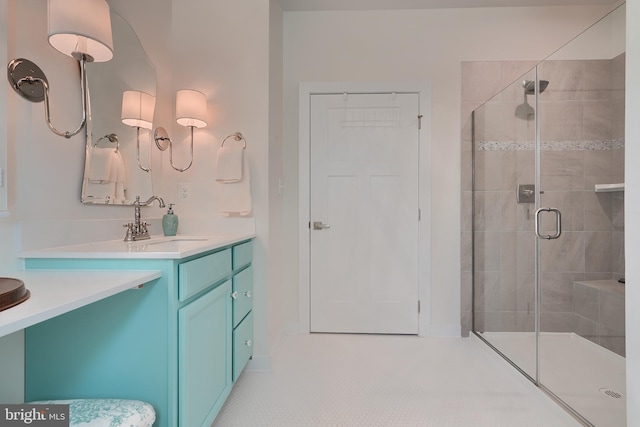 bathroom with vanity and a shower with door