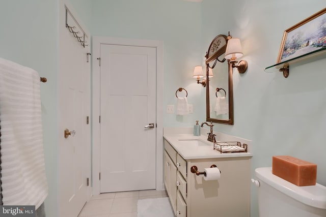 bathroom with vanity, tile patterned floors, and toilet