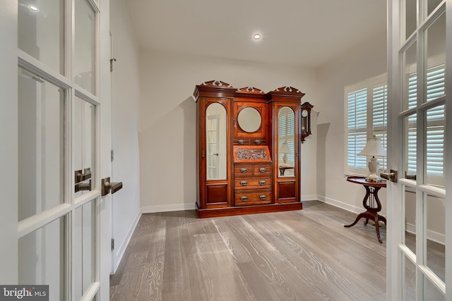 interior space with light hardwood / wood-style flooring and french doors