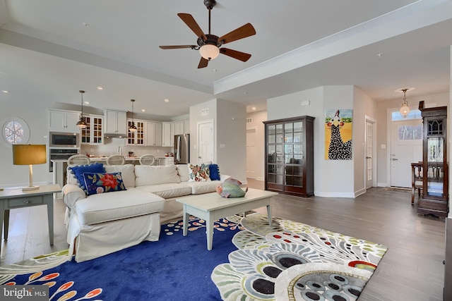 living room featuring dark hardwood / wood-style floors and ceiling fan