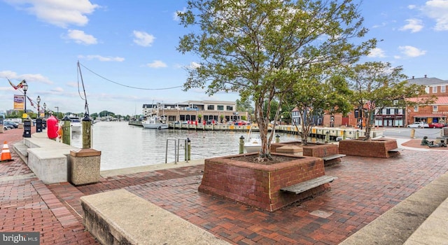 view of patio / terrace featuring a water view and a boat dock