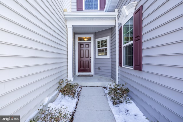 view of snow covered property entrance