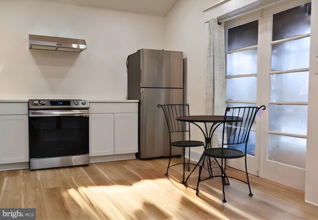 kitchen with white cabinetry, light hardwood / wood-style flooring, and appliances with stainless steel finishes