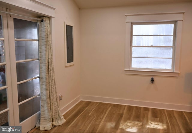 unfurnished room with wood-type flooring and electric panel